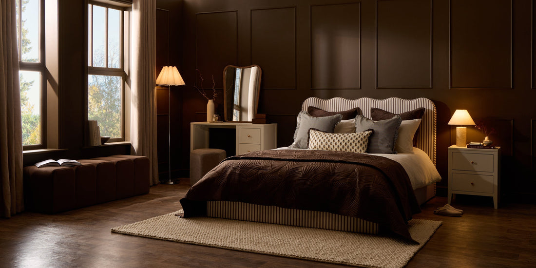 Warm brown bedroom with striped upholstered bed, cream furniture and cosy neutral textures