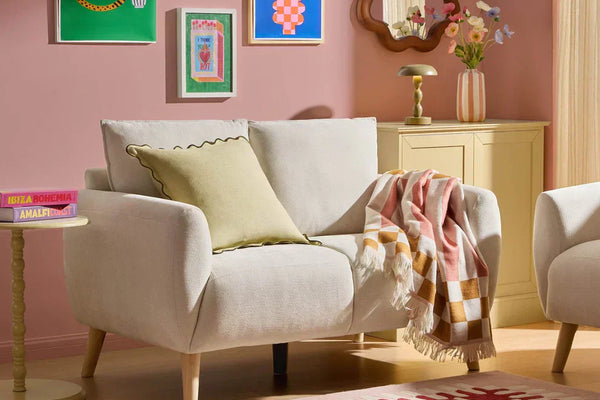 Colourful dopamine decor living room with compact sofa, striped cushions and playful accessoriesColourful dopamine decor living room with compact sofa, striped cushions and playful accessories