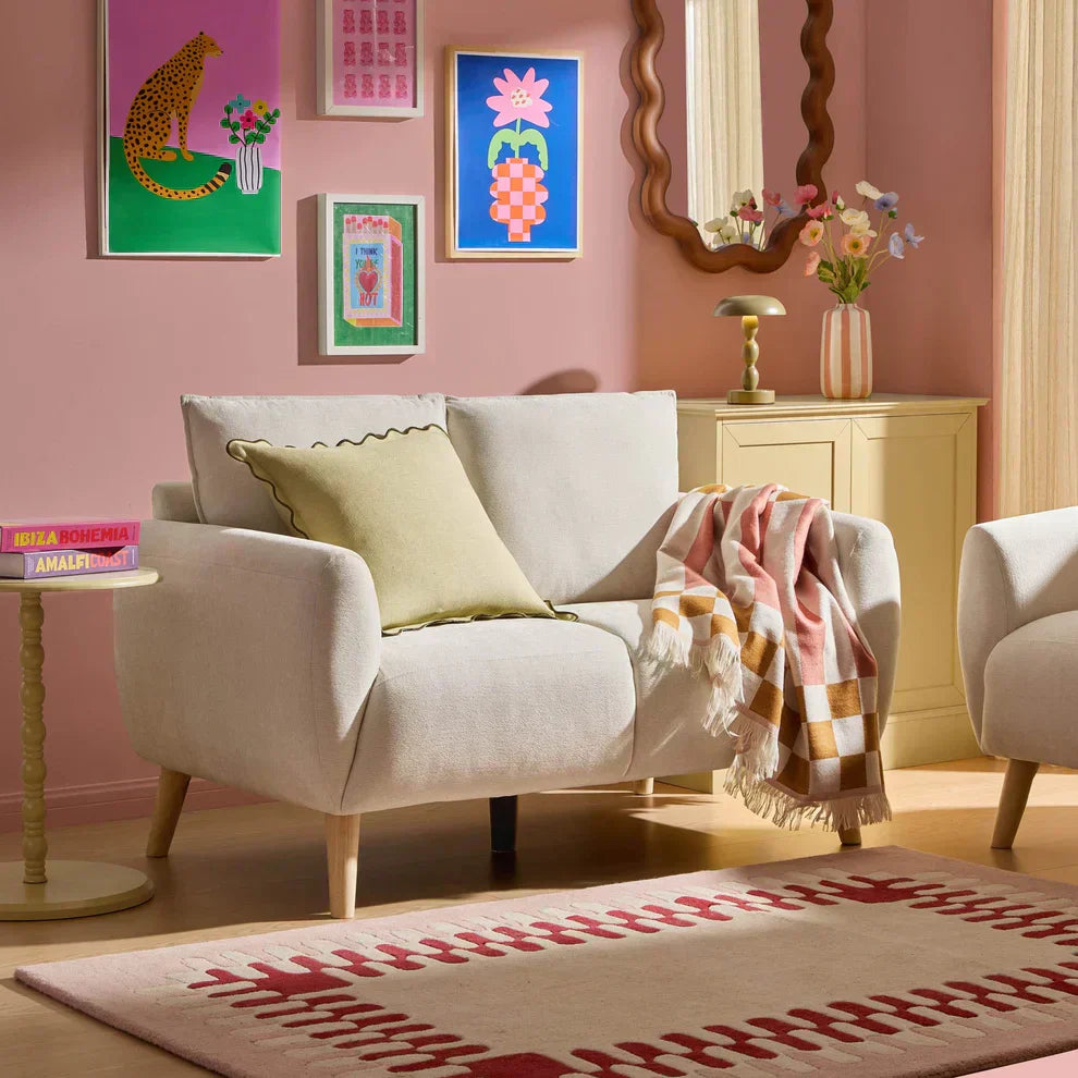 Colourful dopamine decor living room with compact sofa, striped cushions and playful accessoriesColourful dopamine decor living room with compact sofa, striped cushions and playful accessories