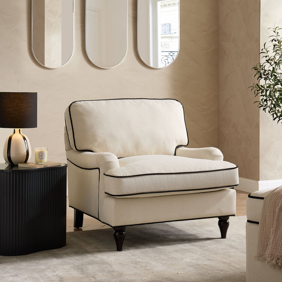 Cream and black armchair from DUSK styled in a quiet luxury interior